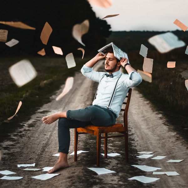 Man with book on their head